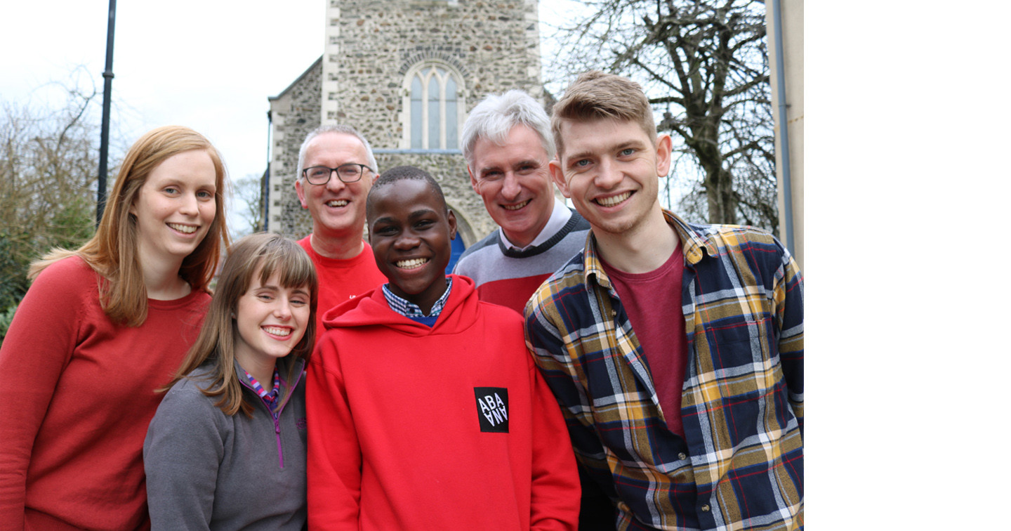 Derrick outside Lisburn Cathedral with, from left: Victoria Bell, Choir chaperone; Sarah Crawford,  Cathedral Children’s Officer; Neville Jones, Abaana Assistant Director; Dean Sam Wright and Gareth Campbell, Cathedral Youth Officer.