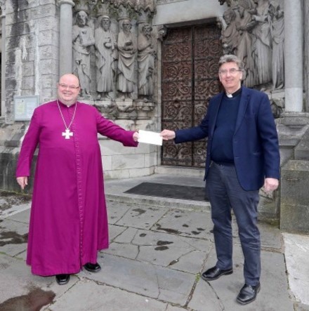 Bishop Colton presents fund–raising proceeds to the Dean of Cork to mark 150th anniversary of St Fin Barre’s Cathedral