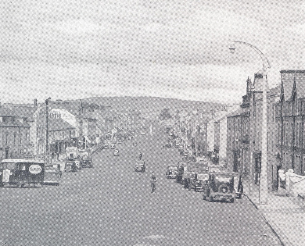 Cookstown's distinctive wide and long Main Street, as it appeared in the early 20th century, from the Tyrone County Handbook (produced by Tyrone County Council)