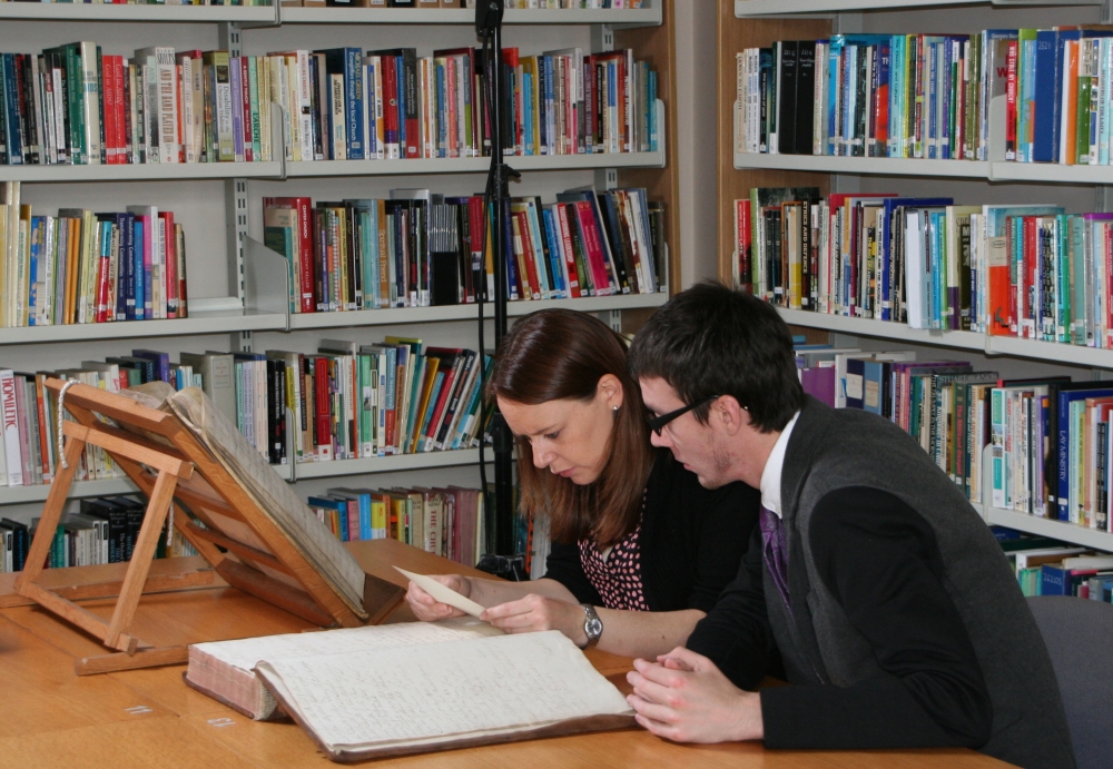 Seaneen Bell and Jason Burke of East Belfast and the Great War Project view the collection in the RCB Library for the first time