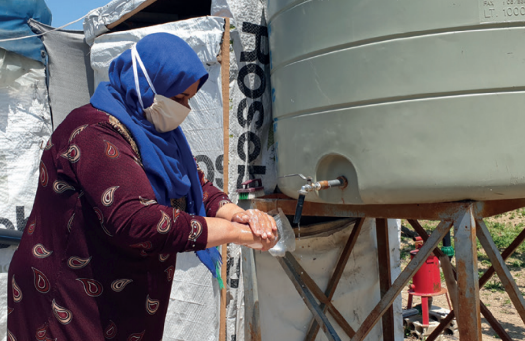 Aida collects water from a Tearfund-supported project in Lebanon's Bekaa Valley.