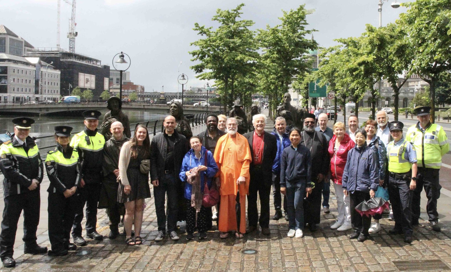 Members of Dublin City Interfaith Forum with some of those who attended the event for World Refugee Day at the Famine Memorial on Custom House Quay, including Assistant Commissioner Paul Cleary and members of An Garda Siochana.