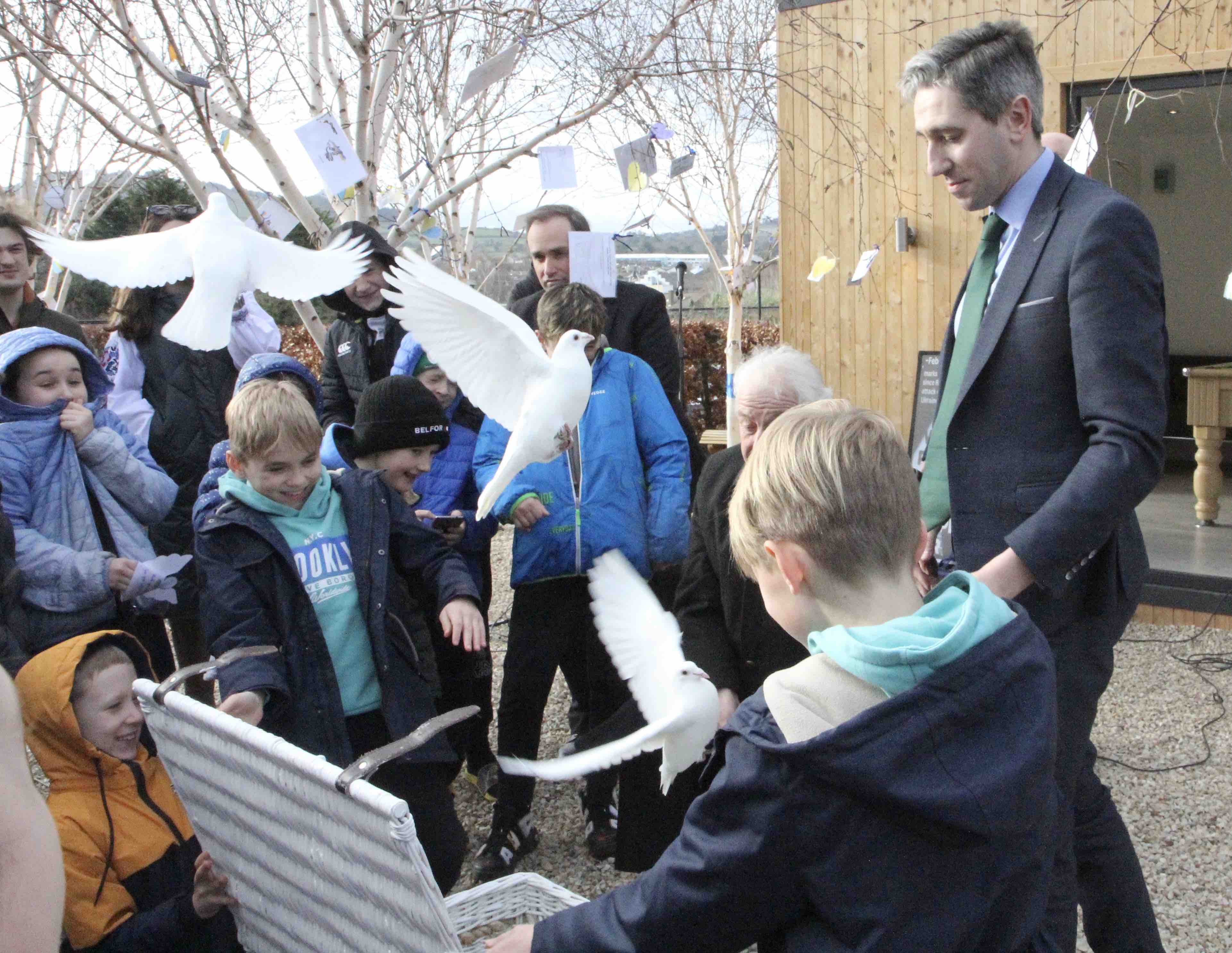 Children from Ukraine, assisted by Archbishop Michael Jackson and Minister Simon Harris, release doves as a symbol of their wish for peace.