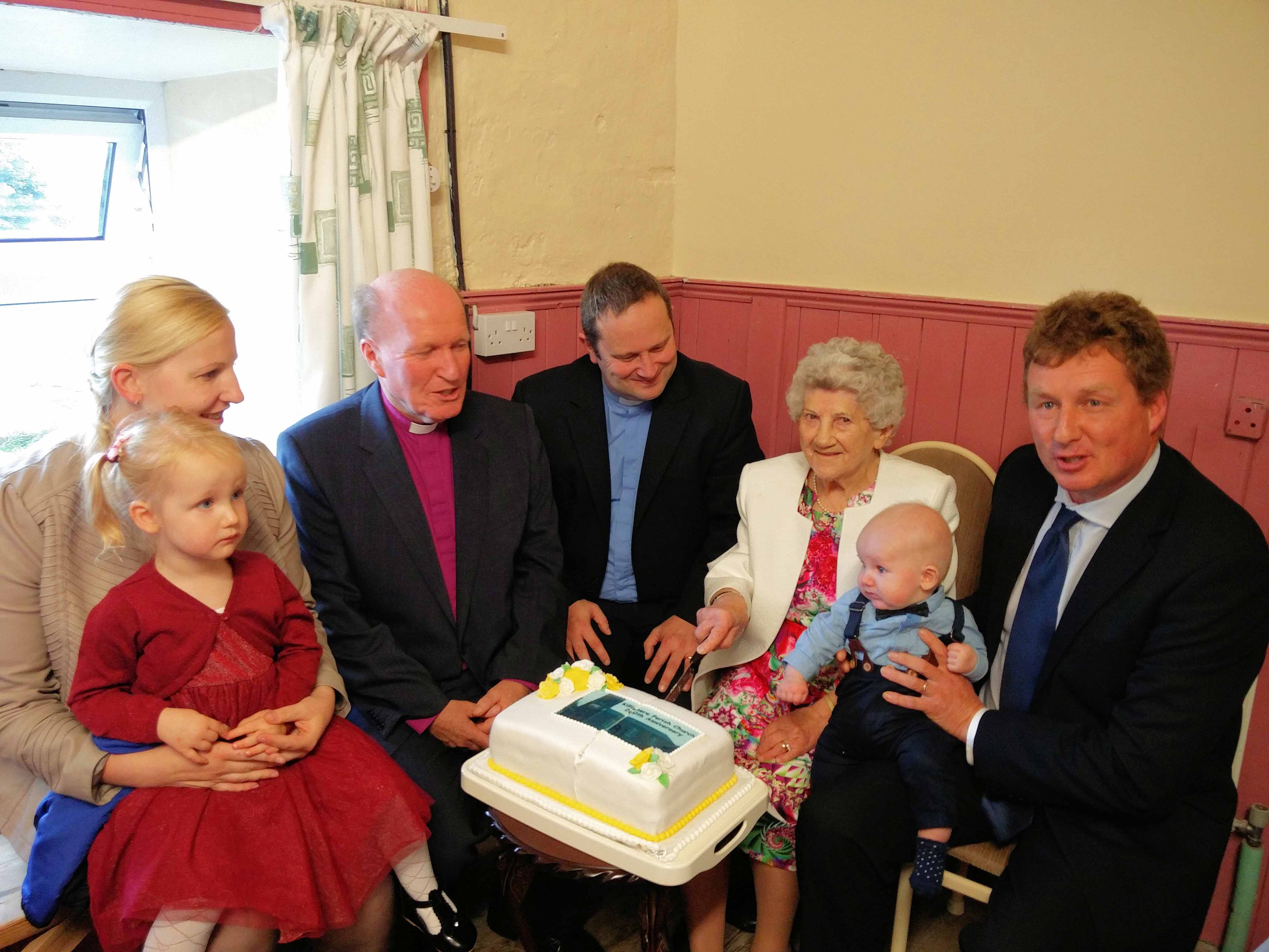 The youngest parishioner - James (with parents Derek and Galina and sister Victoria) and oldest parishioner Betty with the Rector and Bishop Ferran.