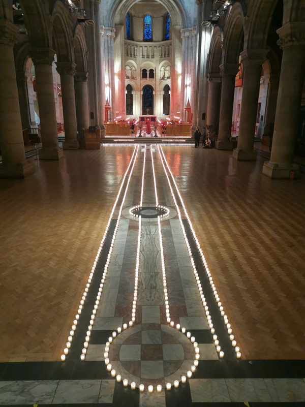 Candles burn in the Nave of St Anne's Cathedral during a Service of Reflection on the anniversary of the national lockdown. The candles represent lives lost to Covid-19 in Northern Ireland.