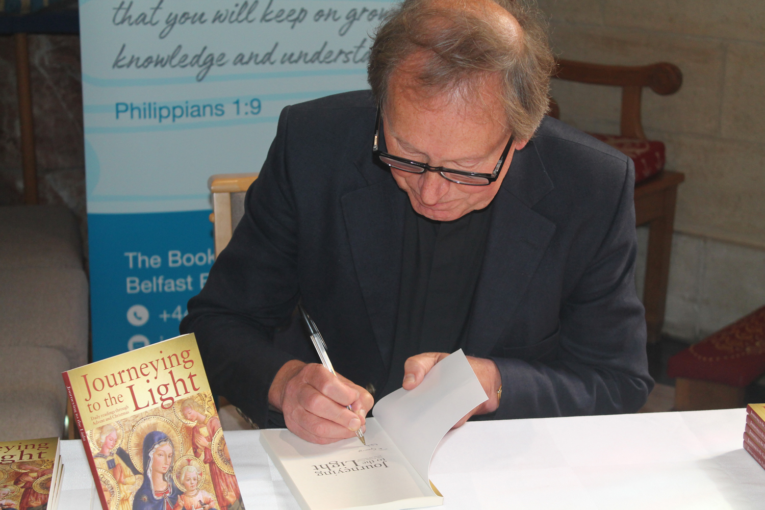 John Mann signs copies of his book.