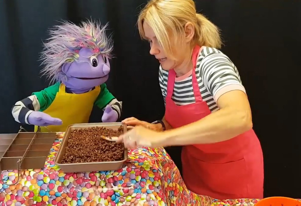 Connor Children's Project Development Officer Jill Hamilton and Jake the puppet bake up a storm as they demonstrate a recipe for the children to follow.