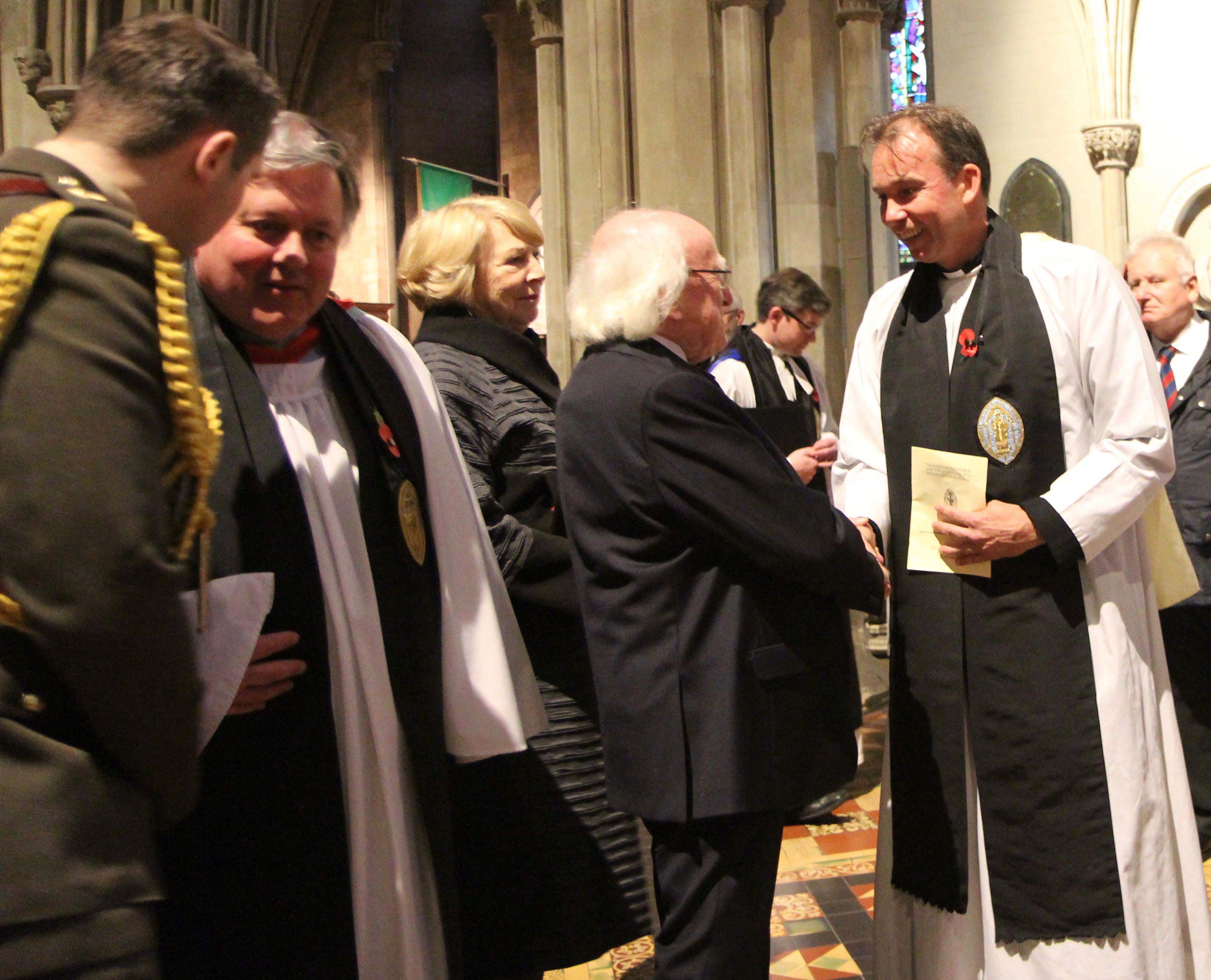 President Michael D Higgins greets the preacher at the Service of Remembrance, Canon Peter Campion. The Dean, the Very Revd William Morton, is also pictured.