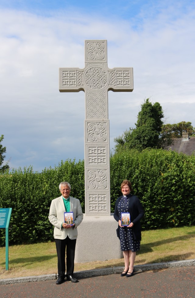 The Very Revd Henry Hull, Dean of Down, and the Revd Karen Salmon pictured with 'St Patrick's Pilgrimages – Journey to Place, Journey to God' at St Patrick's High Cross, a replica of the 8th Century original, at Down Cathedral, Downpatrick.
