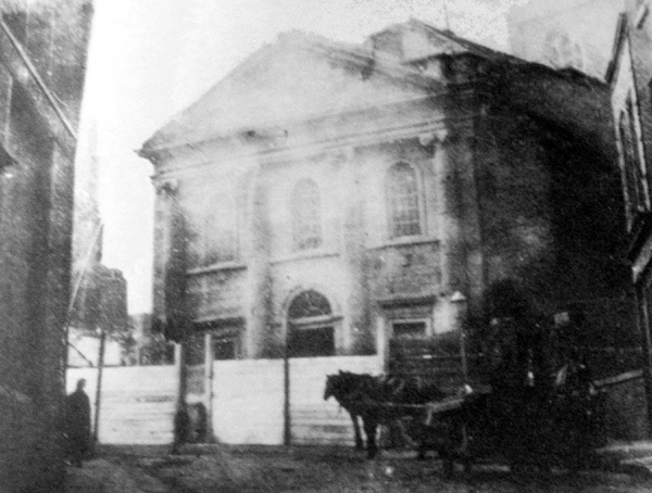 A remarkable early photograph of the church of St John the Evangelist, given that the church itself was closed for worship in February 1879, and demolished in 1884. The existence of scaffolding surrounding the church might suggest that the image was taken close to 1884. From the RCB Library Photograph Collection.